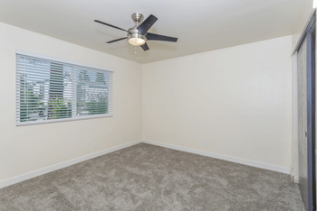 an empty room with a ceiling fan and a window at Gateway, Chico, CA 95926